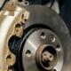 Close-up image of gold painted brake caliper on brake disc.