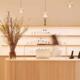 Reception desk with skincare products and a vase of branches