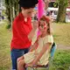 Een meisje krijgt kindergrime op het gezicht in de vorm van een vlinder door cares'tique